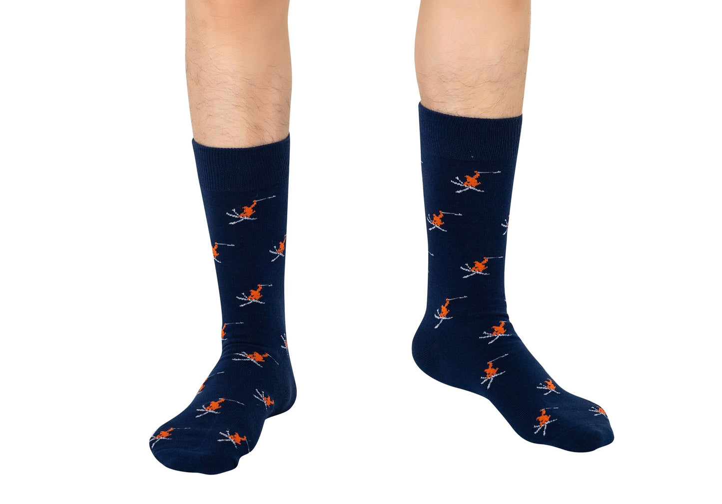 A pair of feet wearing Ski Socks in navy blue with an orange and white skier print, standing on a white background.