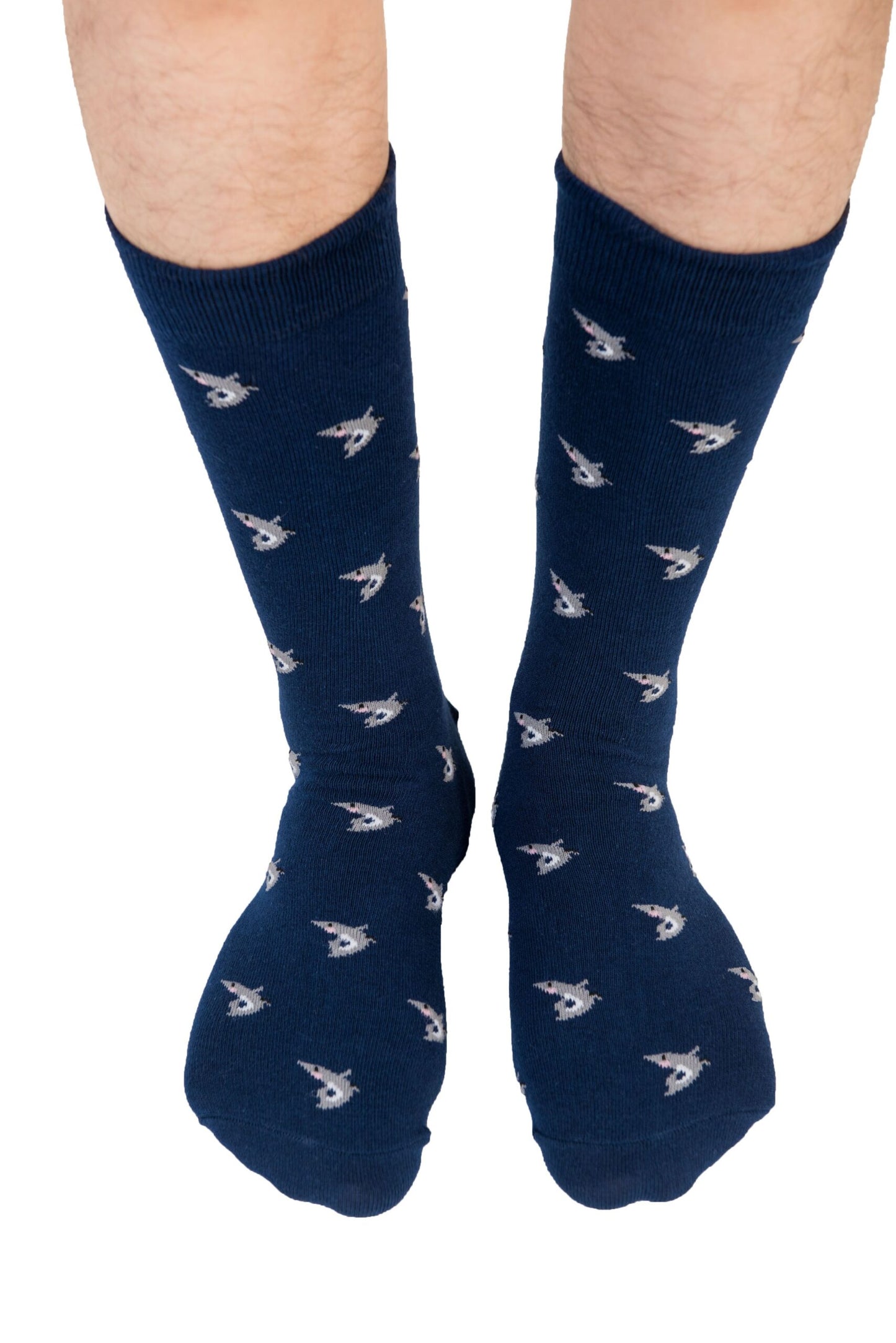 A pair of feet wearing the Shark Socks, adorned with dark blue fabric and small white spaceship patterns against a white background, evoke a deep-sea style that's both unique and eye-catching.