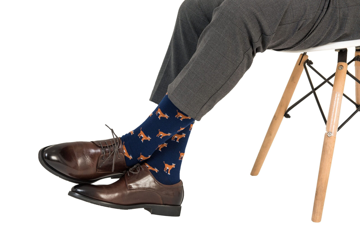A man sitting on a chair wearing Goat Socks.