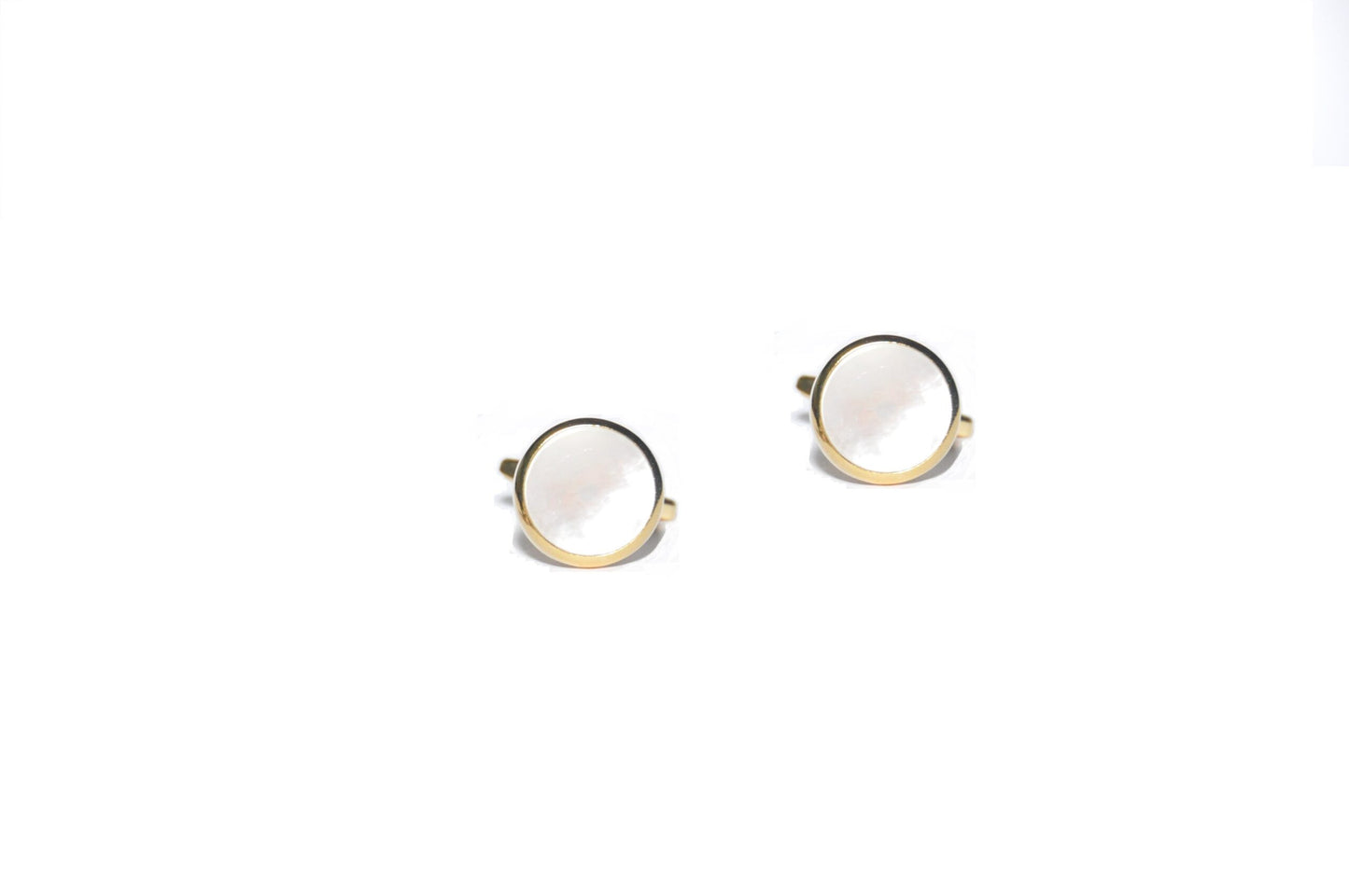 The gold-rimmed Mother of Pearl Cufflinks, resembling ocean's treasures, are elegantly displayed on a white background.