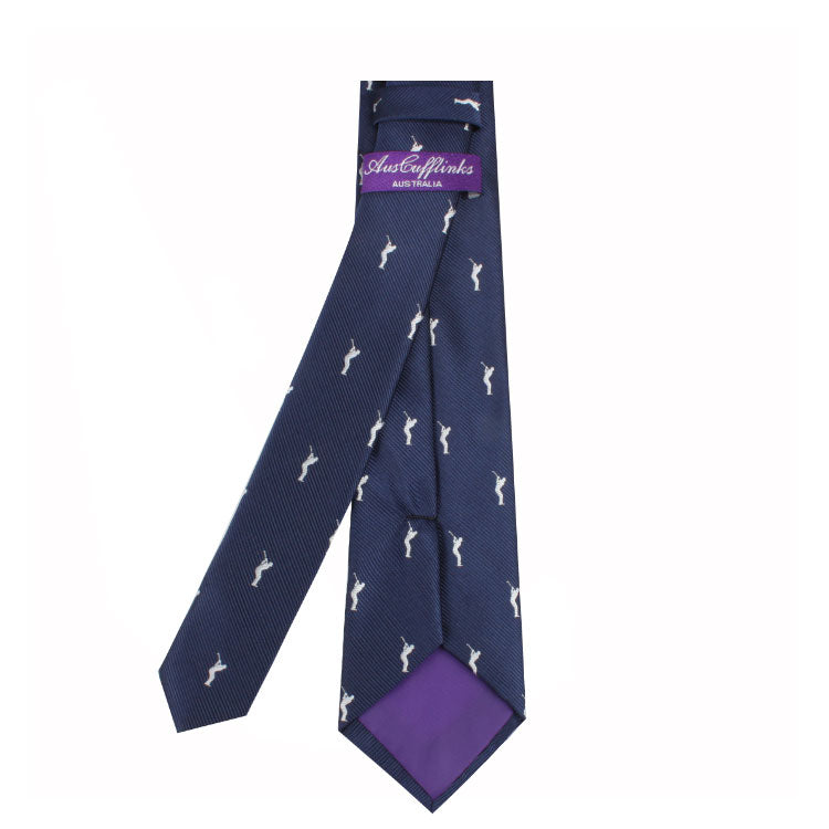 A navy blue Golf Coach Tie with a subtle golf motif of white horse patterns and a purple inner lining, featuring a label that reads "Australian" and "Australia" in cursive script.