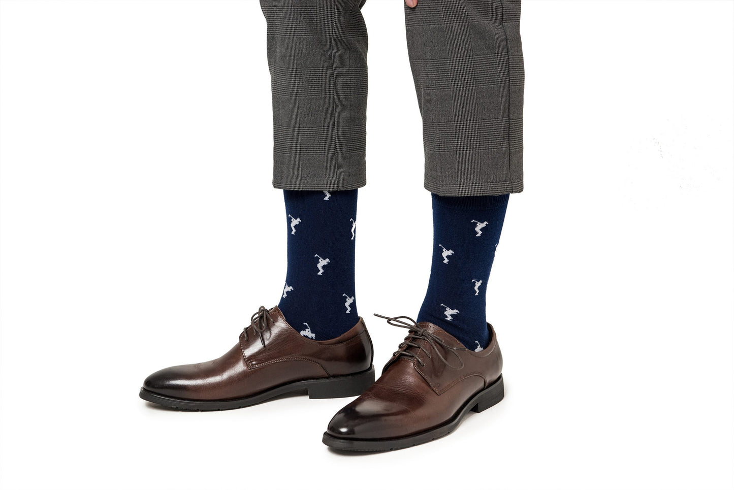 A man wearing a pair of grey pants and Golf Swing Socks.