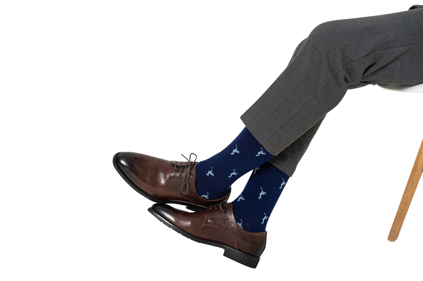 A man wearing Golf Swing Blue Socks is sitting on a chair.