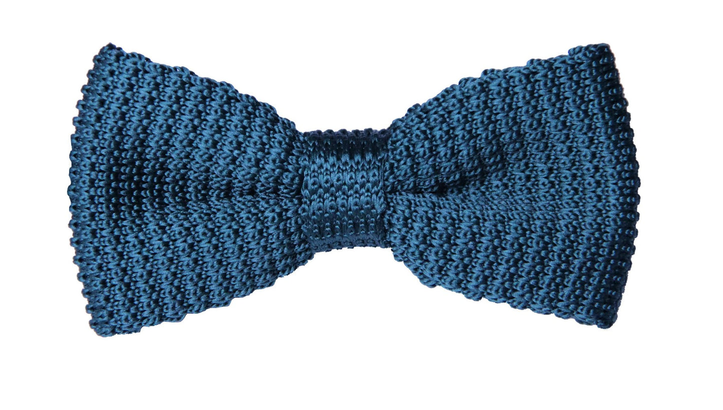 The Green Knit Bow Tie sits on a plain white background, showcasing its earthy sophistication. This textured accessory complements any attire with ease.