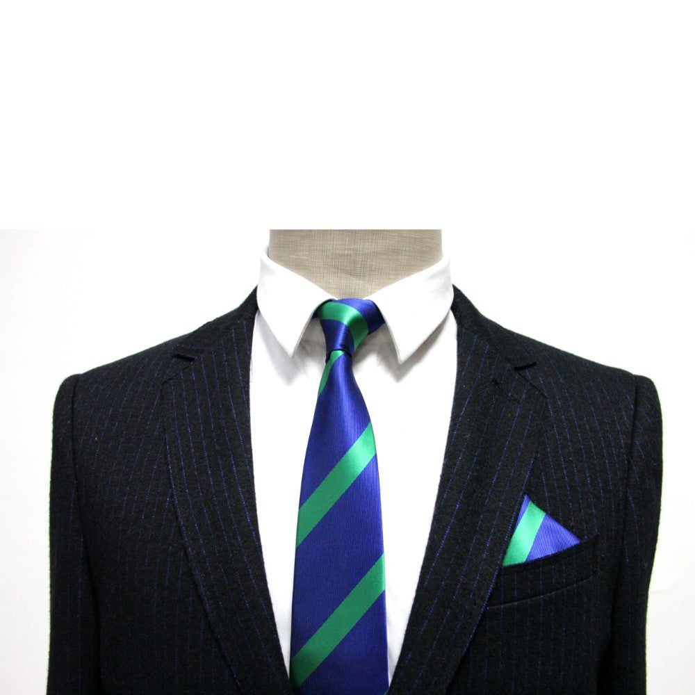 A mannequin displays a dark pinstripe suit and white shirt, paired with a blue tie and accessorized by a Navy Green Stripe Pocket Square, adding sophistication.