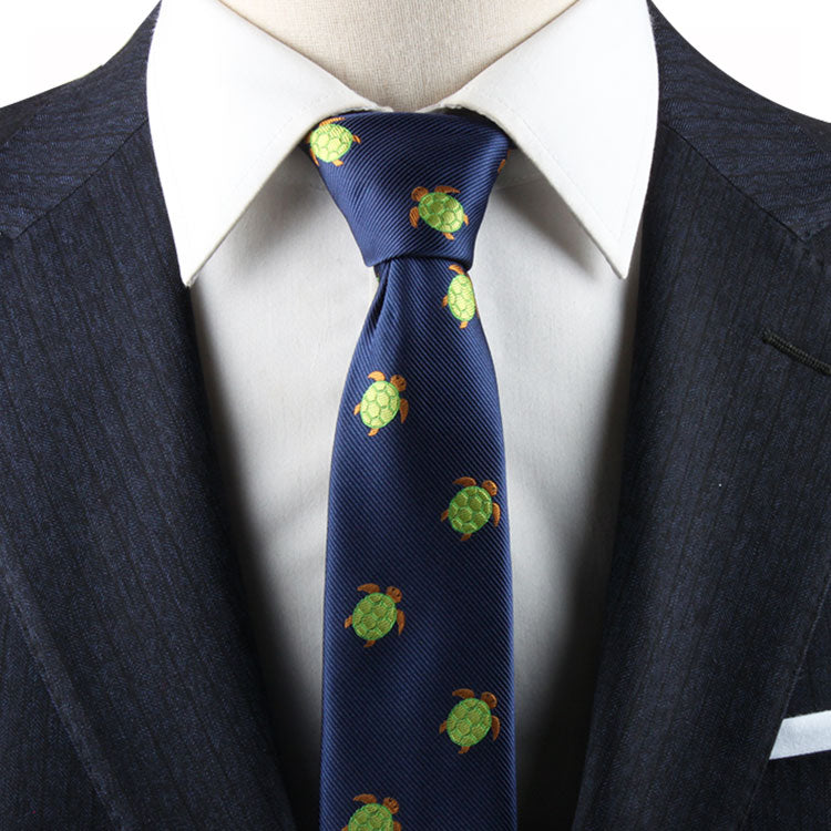 Close-up of a Green Sea Turtle Tie, worn with a white shirt and dark suit jacket, exuding natural elegance.