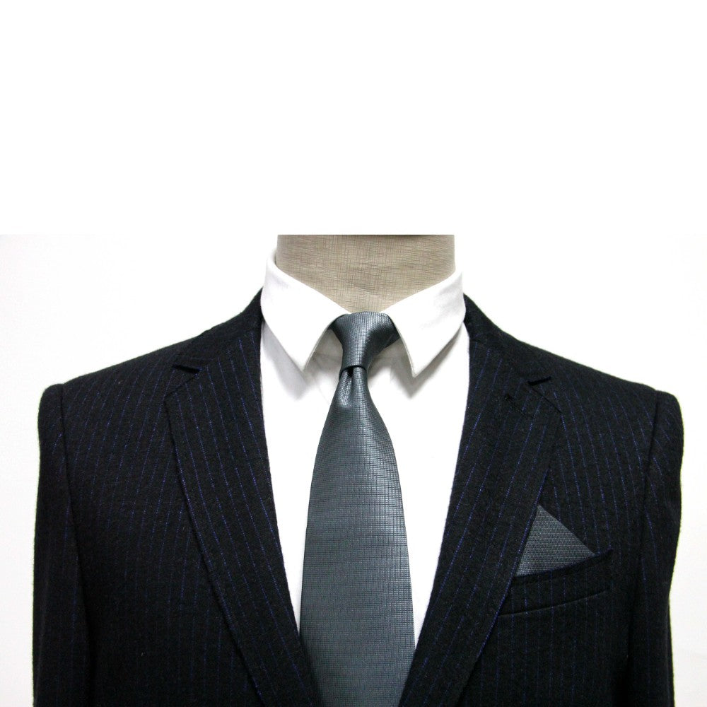 A mannequin dressed in a black pinstripe suit, a white shirt, and a dark tie with the Grey Pocket Square exudes modern elegance against a plain background.