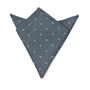 The Grey White Polka Dot Pocket Square, expertly folded into a geometric shape on a plain background, is ideal for any formal occasion as a stylish men's fashion accessory.