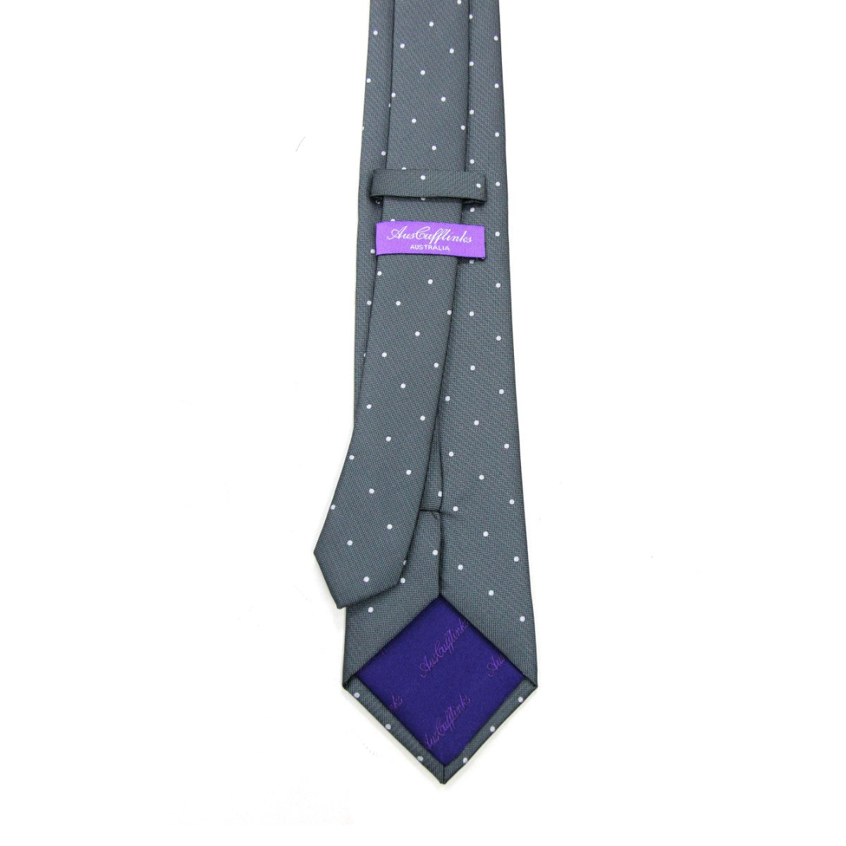 The White Polka Dot Grey Skinny Tie showcases refined elegance, while its label and purple inner lining provide a touch of universal sophistication.