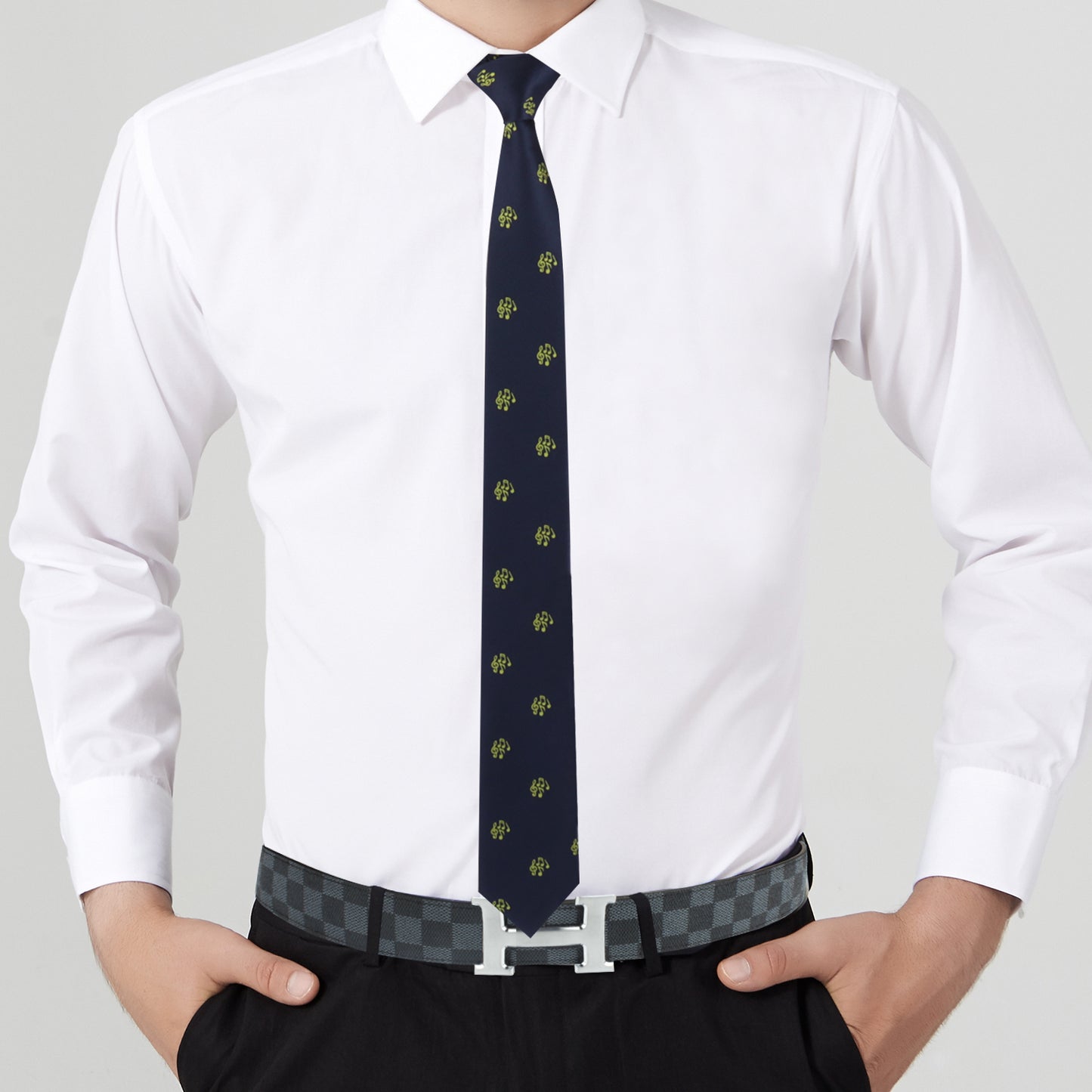 A man in a white dress shirt pairs the look perfectly with the Musical Note Skinny Tie and a black belt featuring a silver buckle, hands in pockets.