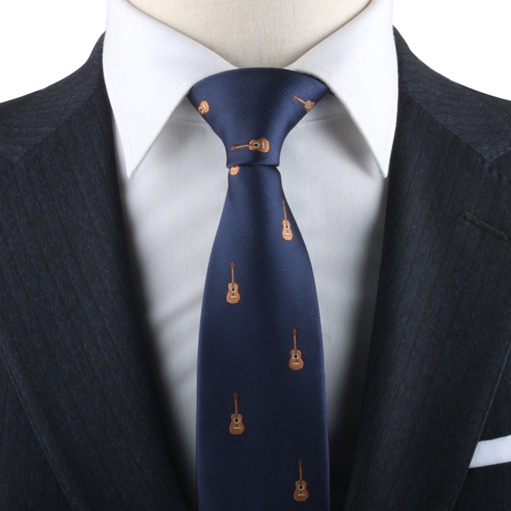 Close-up of a Guitar Necktie, expressed in melodic passion, worn with a white shirt and a dark suit, on a mannequin.