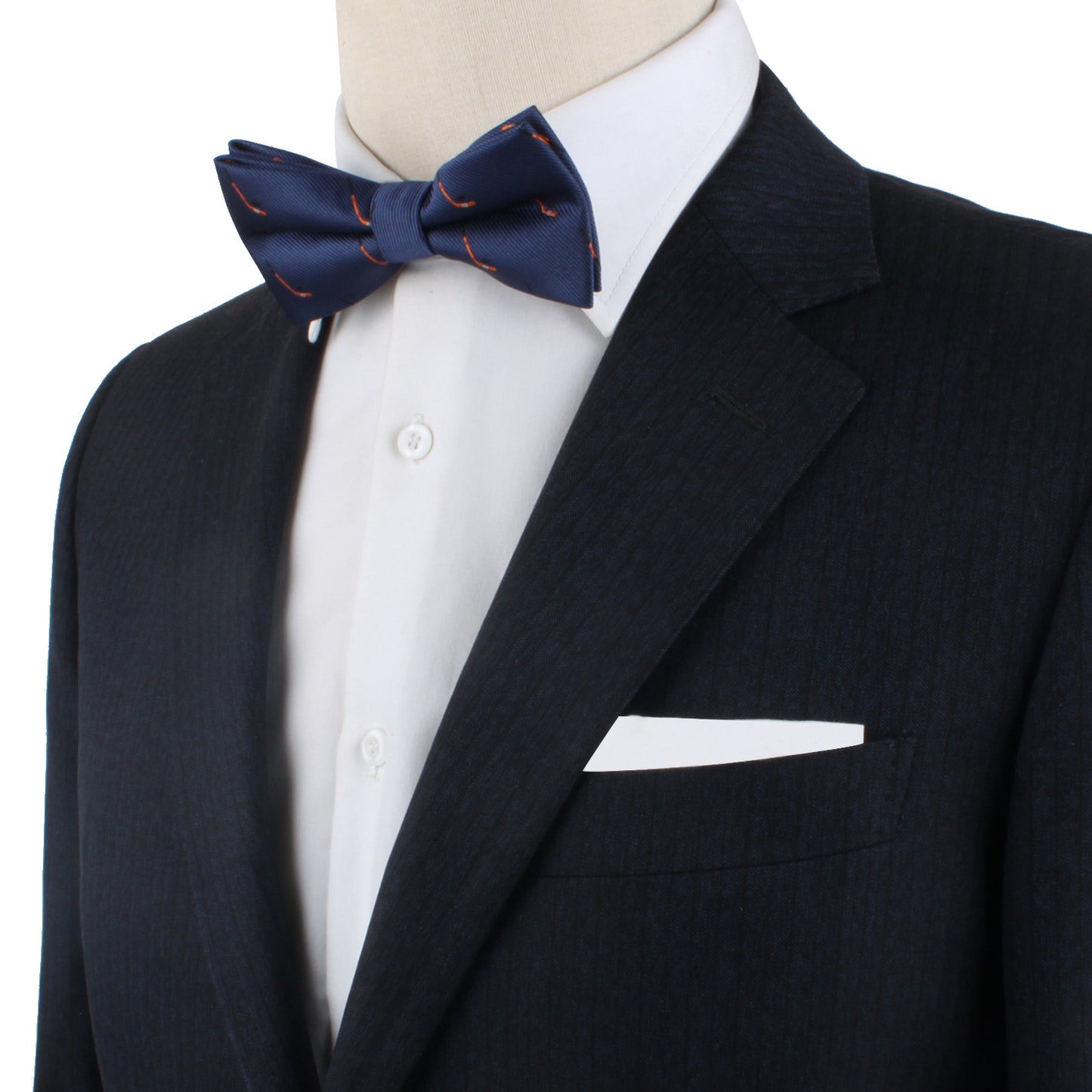 A mannequin exudes icy elegance in a dark suit, paired with a crisp white shirt and the Ice Hockey Bow Tie featuring striking red accents.