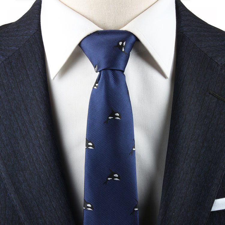 A person wearing a dark pinstripe suit, white dress shirt, and a Killer Whale Necktie exudes contemporary elegance.