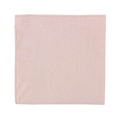 A cream pink pocket square on a subtle white background.
