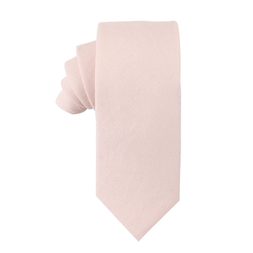 A Cream Pink Skinny Cotton Tie showcased against a white background, providing a soft touch.