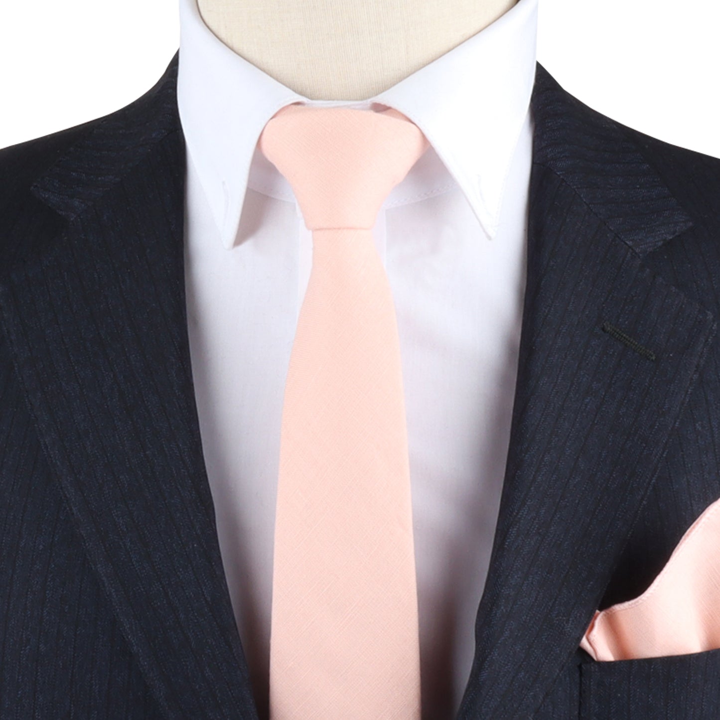 A black pinstripe suit accompanied by a white shirt, light pink tie, and a Baby Pink Pocket Square exudes delicate elegance.