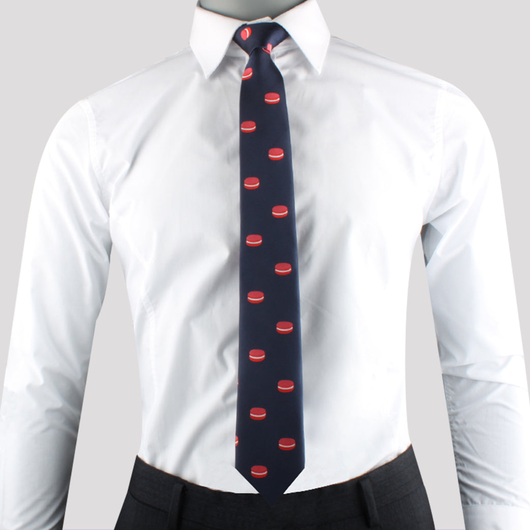 Someone is wearing a white dress shirt and the Macaron Skinny Tie, featuring an appealing red macaron pattern ideal for dessert enthusiasts.