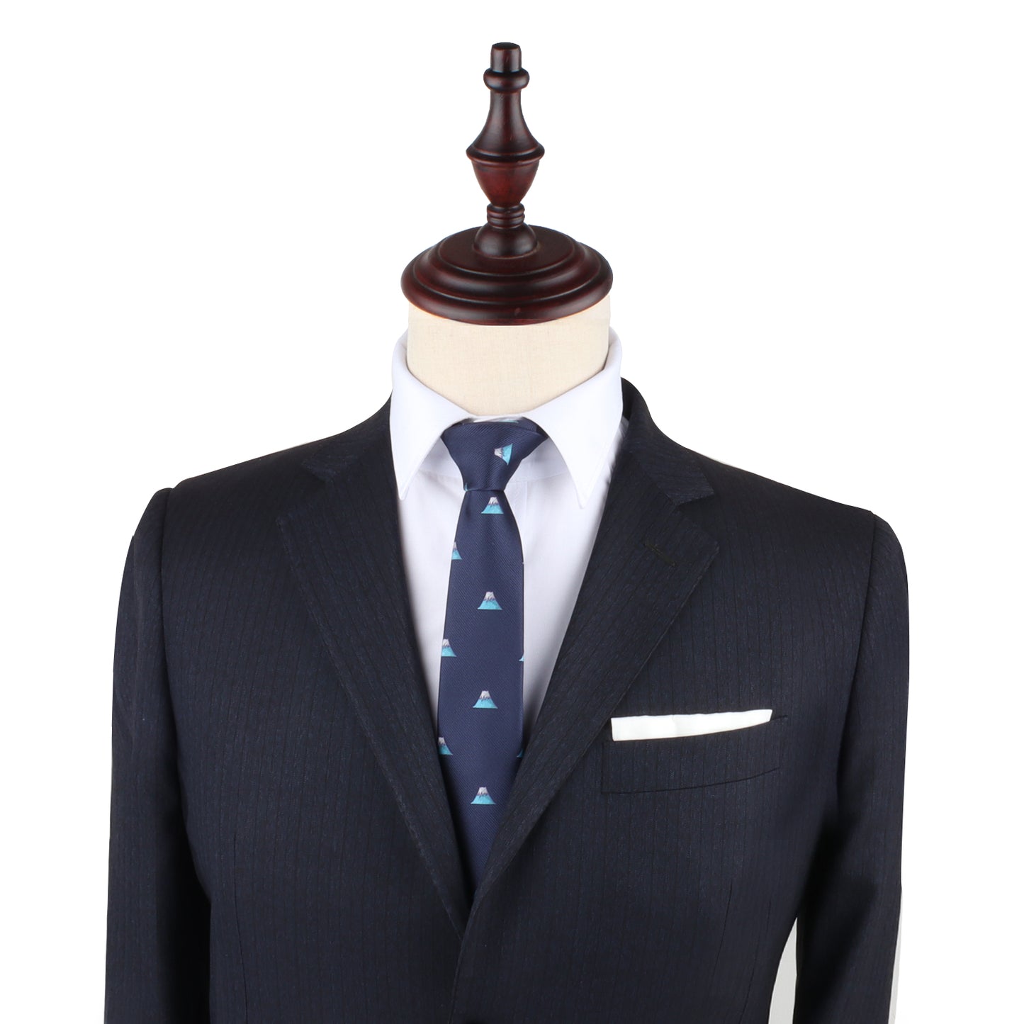 Mannequin dressed in a dark navy suit, white dress shirt, and Mountain Slim Tie, exuding a timeless style against the plain background.