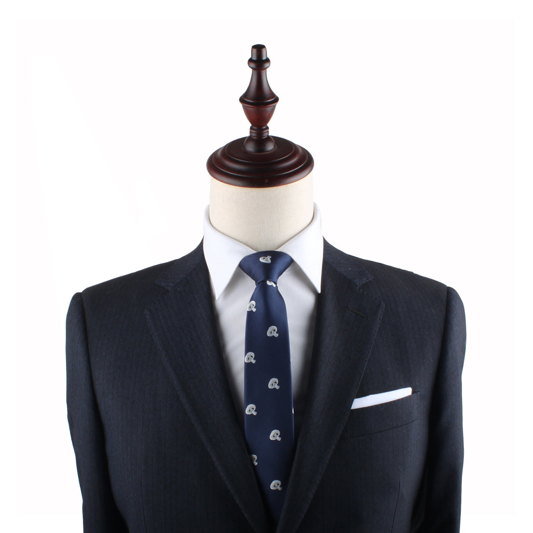 A mannequin dressed in a dark suit jacket, white shirt, and the Mushrooms Slim Tie exudes elegance against the plain white background.