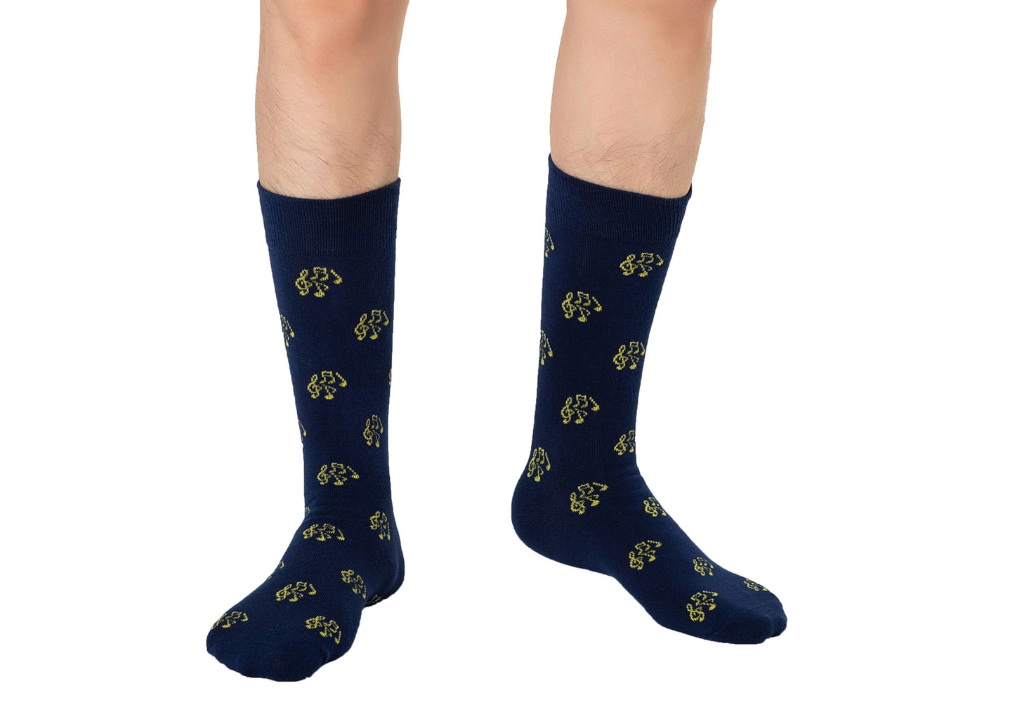 Someone wearing Musical Note Socks in navy blue with a yellow musical note pattern, ideal for music lovers, standing against a white background.