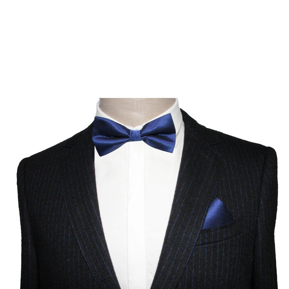 A mannequin showcases sophistication in a dark pinstripe suit with a crisp white shirt paired with a Classic Navy Bow Tie and matching blue pocket square, ideal for formal events.