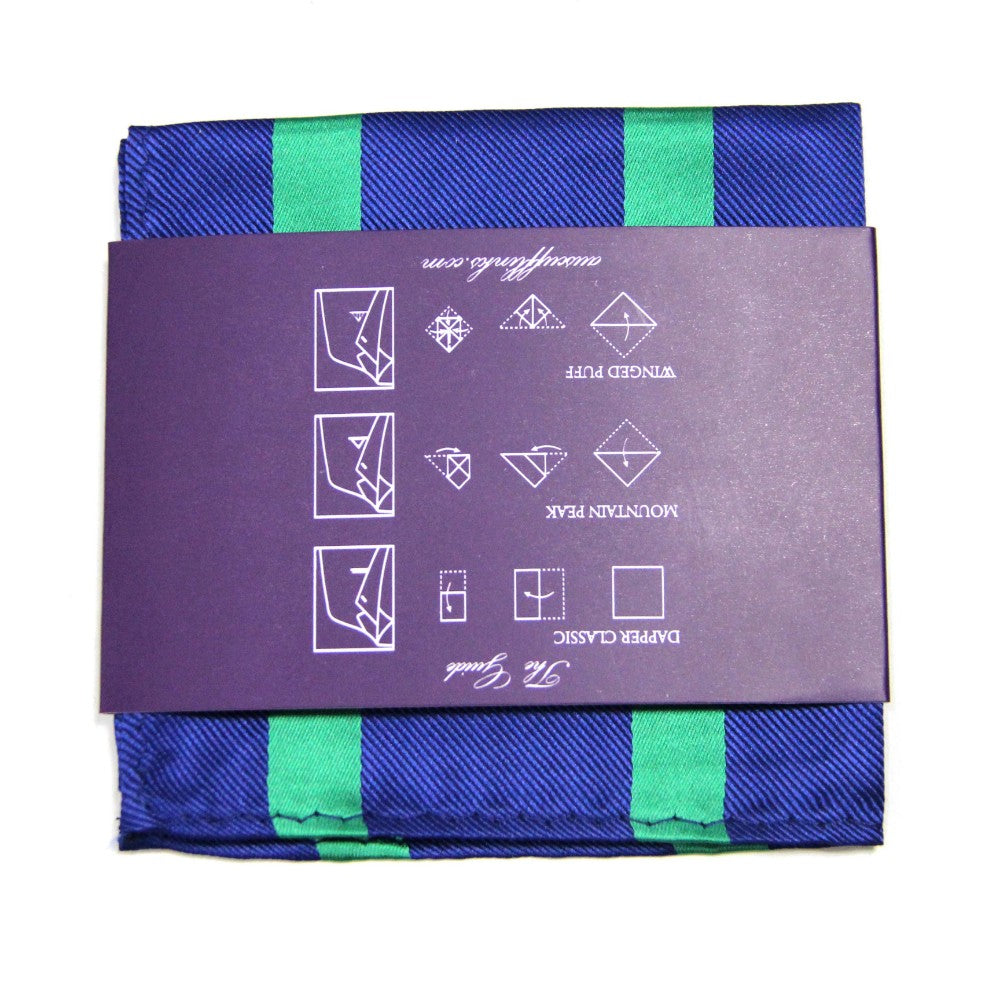 A folded navy and green pocket square from the Navy Green Stripe Business Tie & Pocket Square Set, featuring a purple wrapping with illustrated folding instructions, exuding polished charm.
