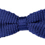 The Navy Knit Bow Tie is a sophisticated accessory featuring a textured woven pattern on a crisp white background.