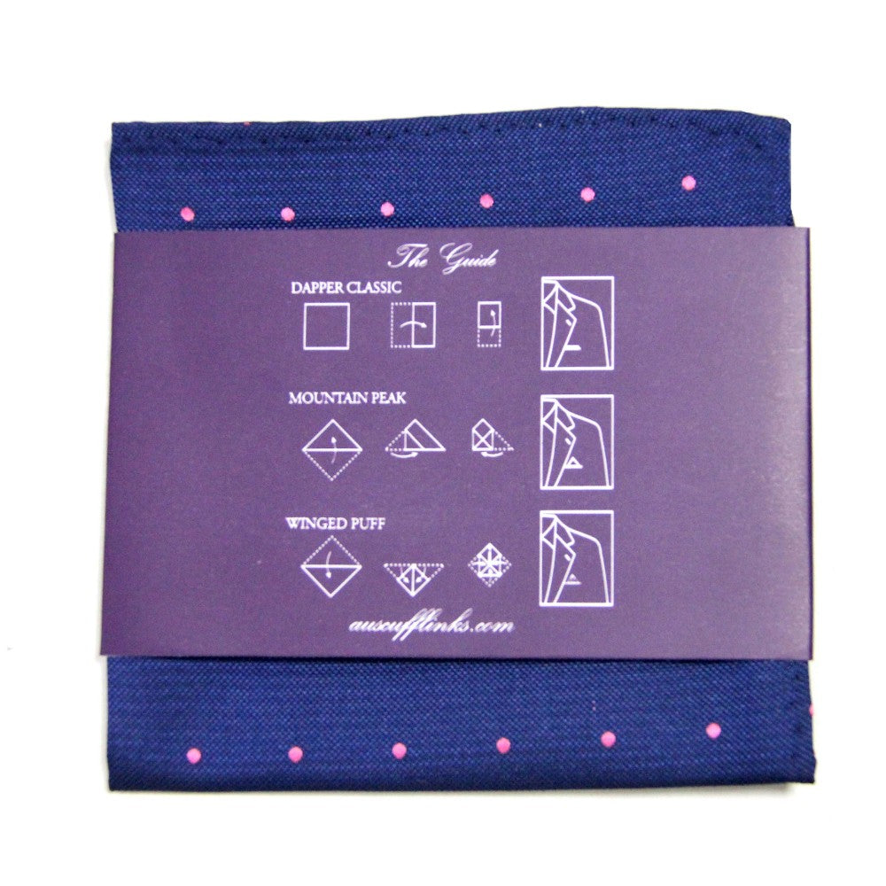 The Navy Pink Polka Dot Business Tie & Pocket Square Set includes a navy pocket square with pink dots, complemented by an instructional card that demonstrates three folding styles: Dapper Classic, Mountain Peak, and Winged Puff, which infuse sophistication into any outfit.