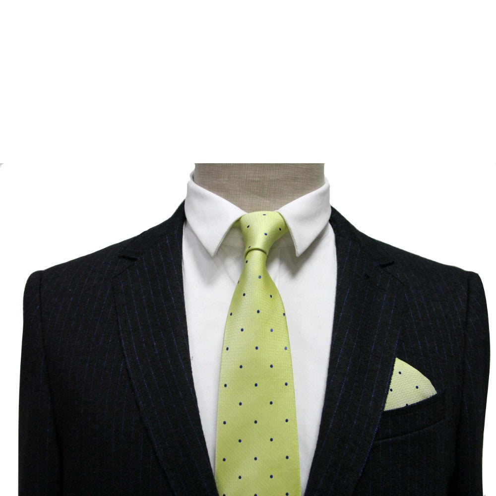 A mannequin elegantly displays men's fashion with a dark pinstripe suit and crisp white shirt, adorned by a light green polka dot tie and the Green Navy Polka Dot Pocket Square, adding flair.