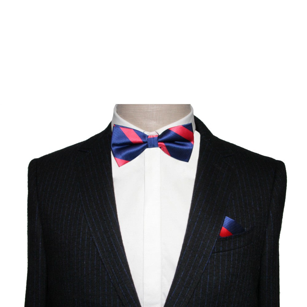 A mannequin wears a dark pinstripe suit with a white shirt, radiating classic elegance. Styled with the Navy Red Pink Stripe Bow Tie and matching pocket square, it serves as the perfect stylish accessory.