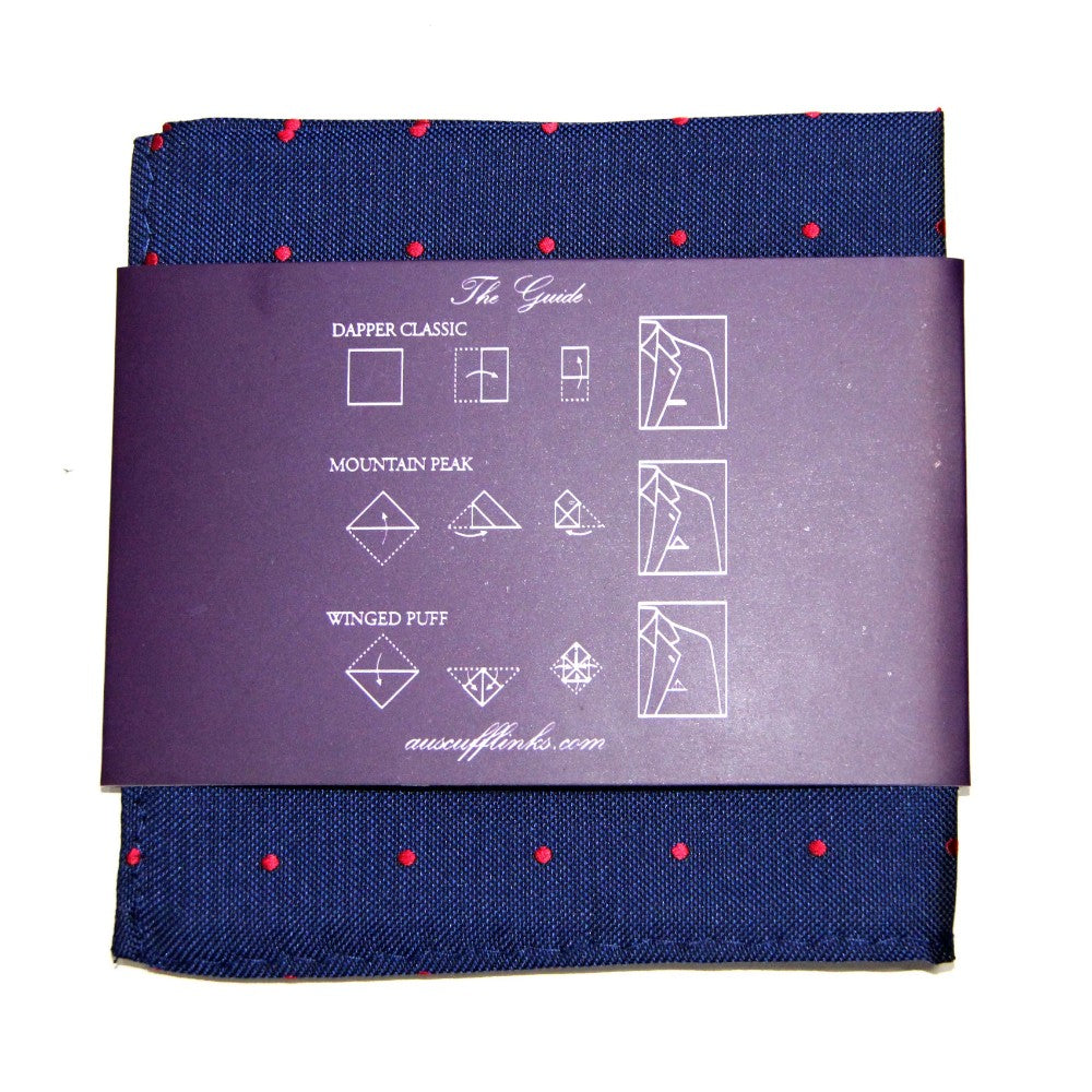 The Navy Red Polka Dot Business Tie & Pocket Square Set comes elegantly wrapped in purple paper and includes folding instructions for Dapper Classic, Mountain Peak, and Winged Puff styles—an ideal addition to any business tie collection.
