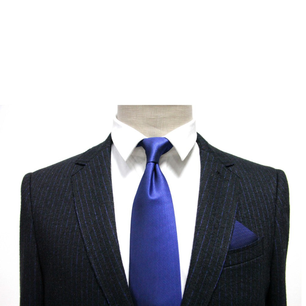 A mannequin wears a dark pinstripe suit with a white shirt, royal blue tie, and Navy Pocket Square against a plain white background—ideal formalwear for the modern gentleman.