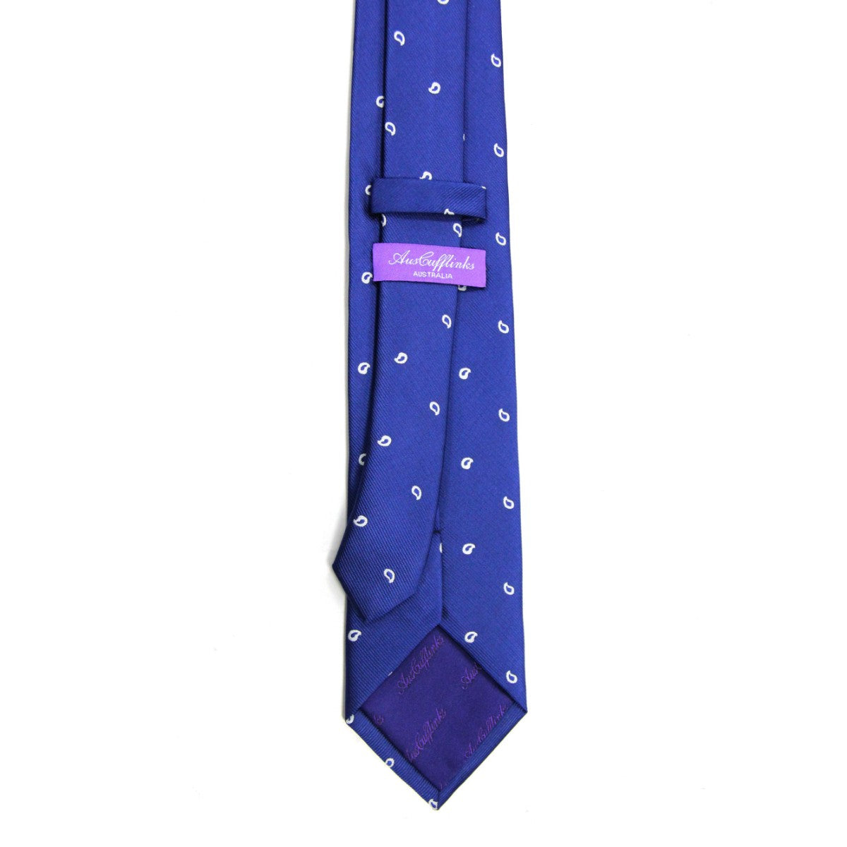 The Navy Tear Drop Skinny Tie, featuring elegant white paisley designs and a purple label, is showcased against a crisp white background, making it the perfect accessory for any sophisticated wardrobe.