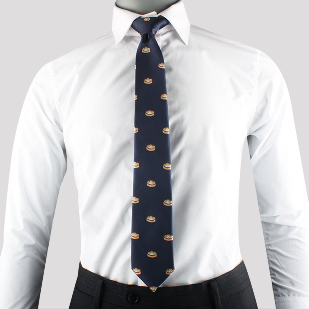 A person is wearing a white dress shirt with a Dumplings Skinny Tie, exuding timeless elegance. The outfit is paired with dark pants.