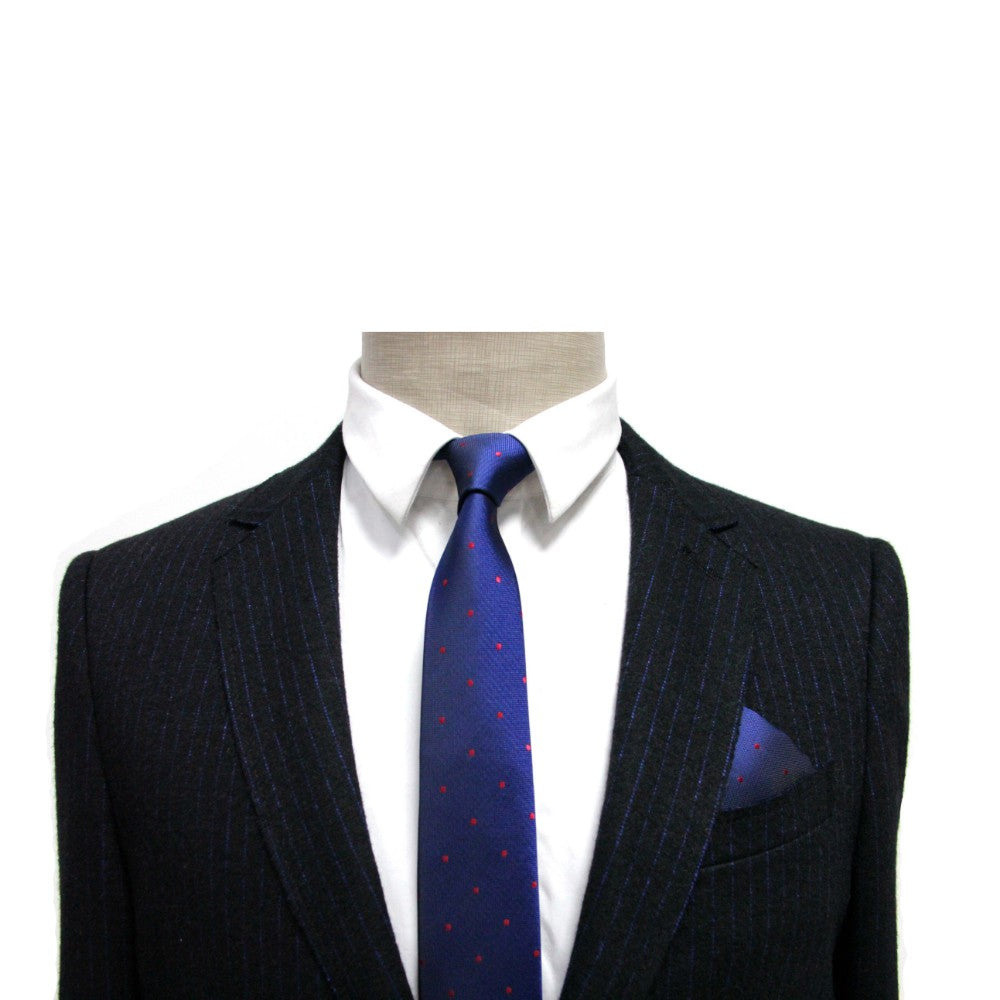 The navy pinstripe suit on the mannequin is a men's fashion essential, styled with a crisp white shirt and a blue tie adorned with red dots. Completing this formal ensemble against the white backdrop is the Navy Red Polka Dot Pocket Square for an added touch of elegance.