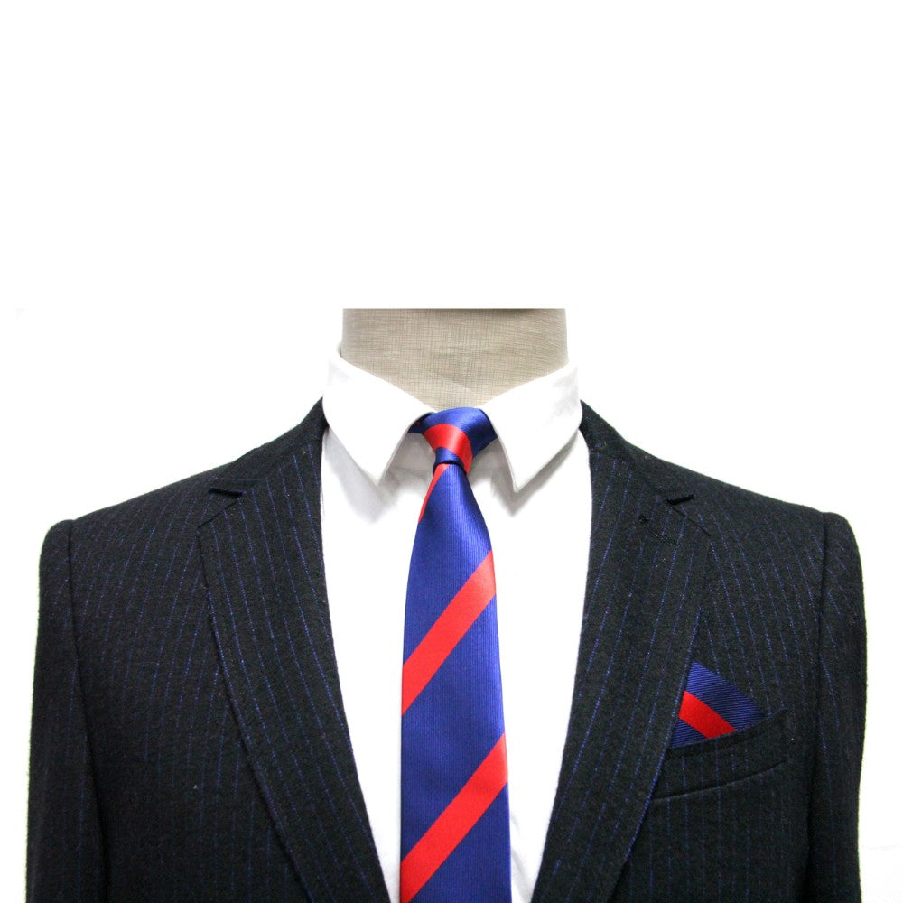 A mannequin in a dark pinstripe suit with a white shirt and blue tie featuring red diagonal stripes showcases classic elegance, while the Navy Red Stripe Pocket Square in the breast pocket adds refined sophistication.