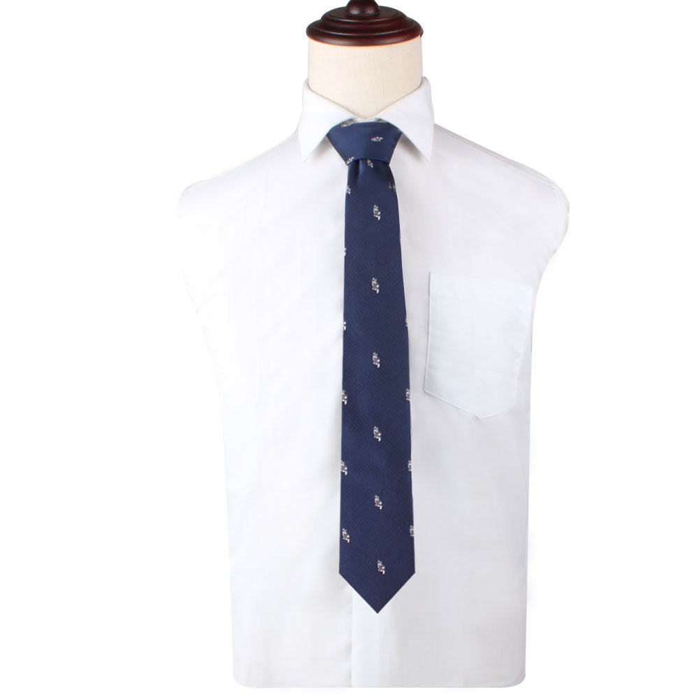A cream-colored shirt with a Novelty Cat Tie featuring a subtle cat pattern exudes both charm and sophistication, displayed elegantly on an armless mannequin.