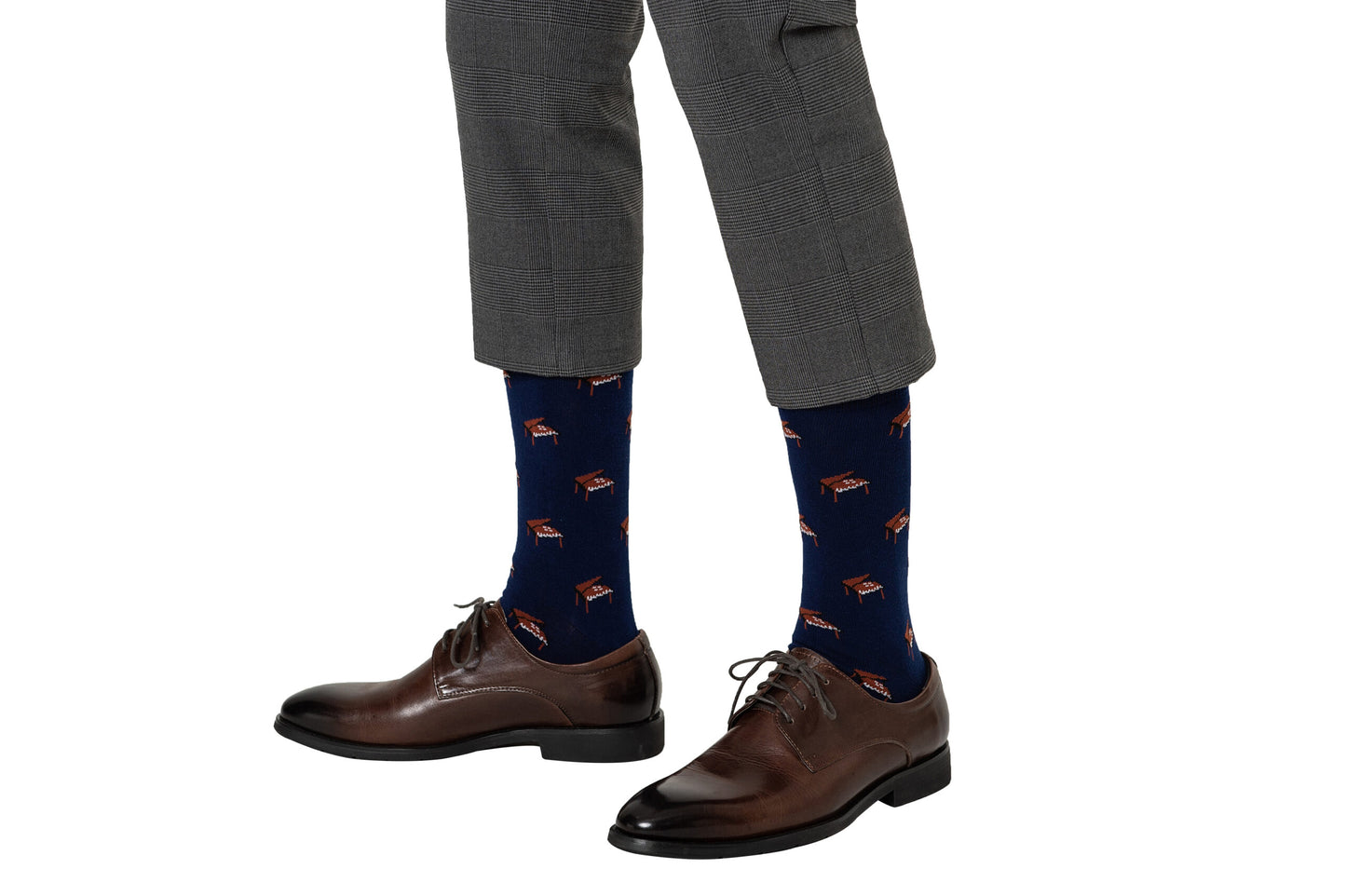 Man wearing gray plaid pants, brown dress shoes, and Piano Socks in navy blue with a grand piano pattern—unique music socks ideal for anyone looking for special musician gifts.