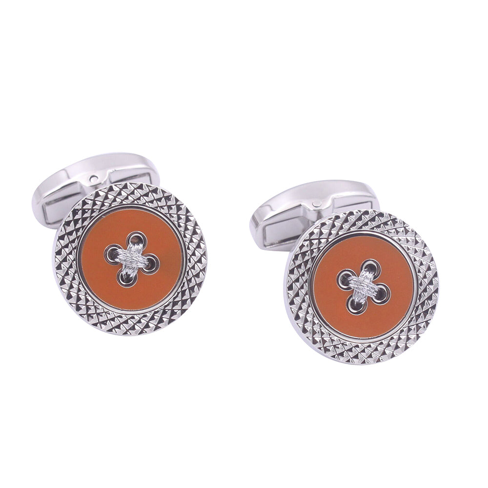 The Orange Button Cufflinks, ideal for special occasions, incorporate two silver pieces with round orange button-like faces. Textured edges and a central knot offer a modern twist on the classic cross design.