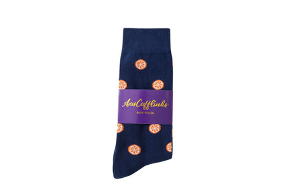A pair of dark blue Orange Socks with orange bicycle patterns and a purple label displaying the brand "aussie cufflinks australia" offers heel to toe citrusy comfort.