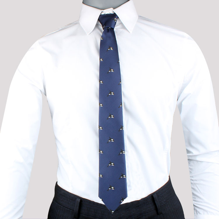 A person wearing a white dress shirt and a Orca Pattern Tie exudes contemporary elegance. The background is plain light grey, adding to the allure of the scene.