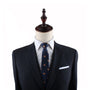 Mannequin torso displaying a navy suit with a Pancakes Slim Tie and pocket square.