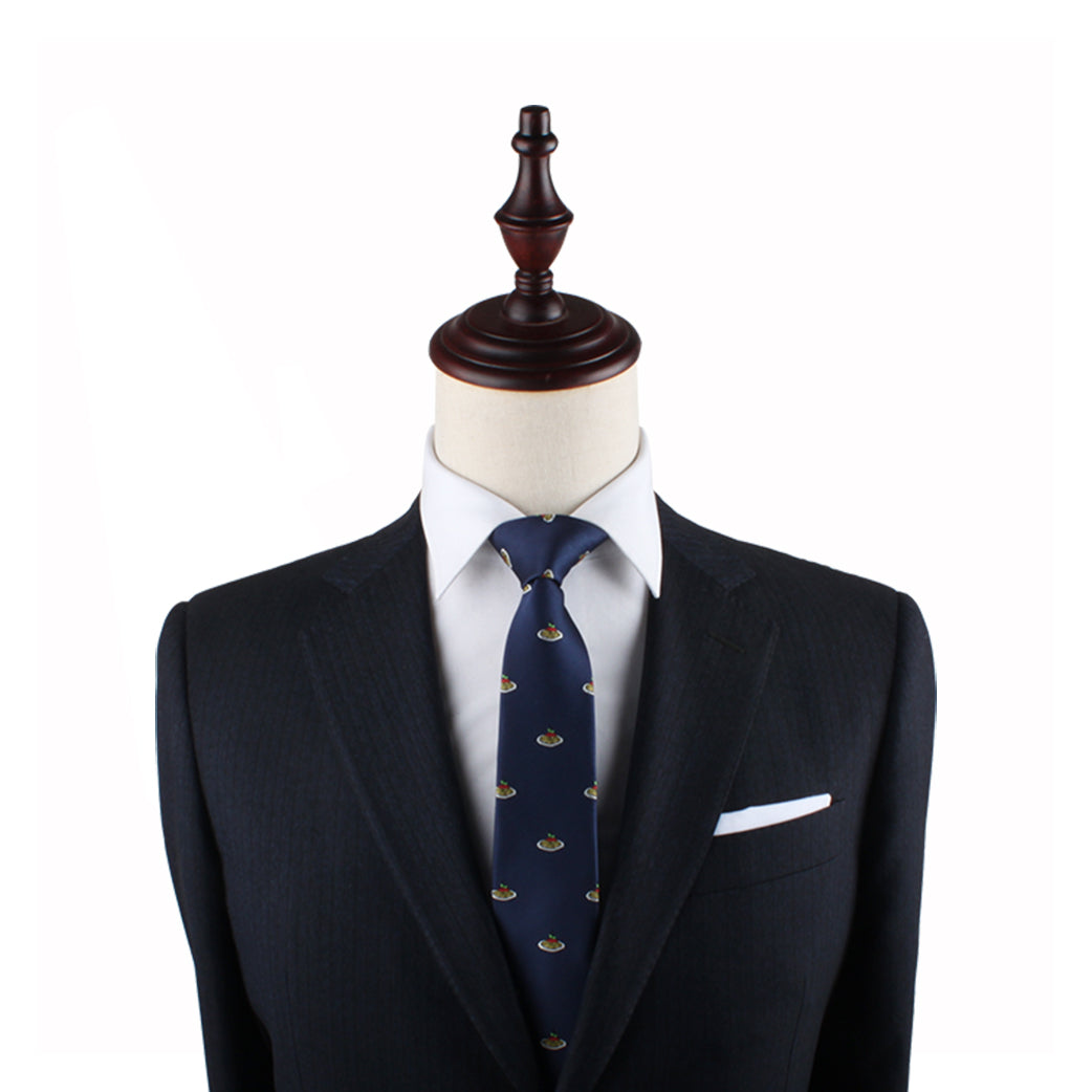 A tailored dark suit with a white dress shirt and the Pasta Thin Tie, featuring a small emblem pattern, displayed on a headless mannequin, epitomizes modern style with a touch of Italian flair.