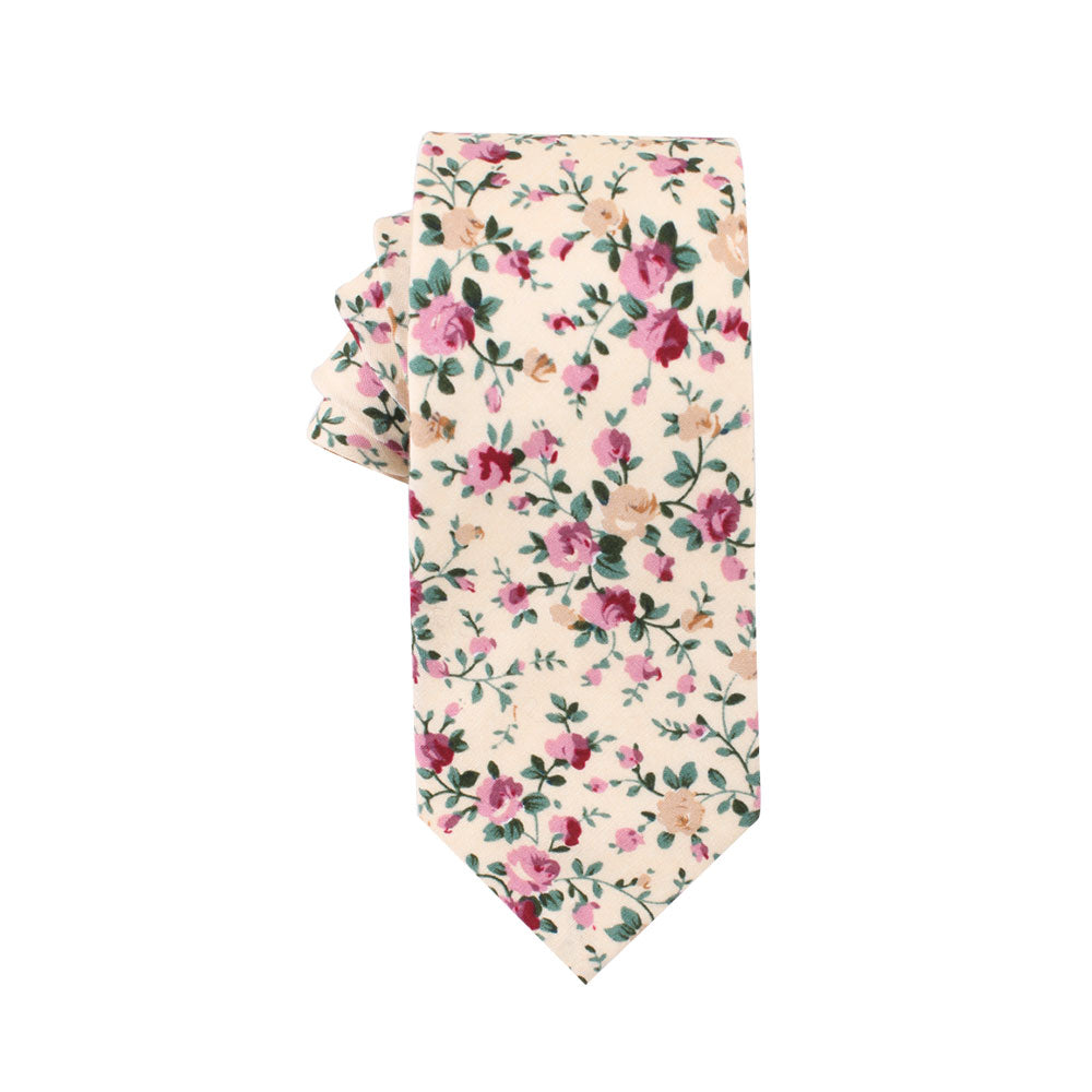 Introducing the Pastel Pink Rose Floral Cotton Skinny Tie and Pocket Square Set: a cream-colored necktie adorned with a floral pattern showcasing pink and beige roses in full bloom, complemented by green leaves, adding a touch of elegance.