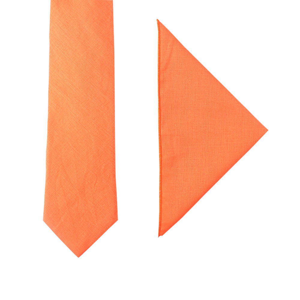 The Peach Orange Cotton Business Tie & Pocket Square Set, showcasing a striking flair, is elegantly displayed against a crisp white background.