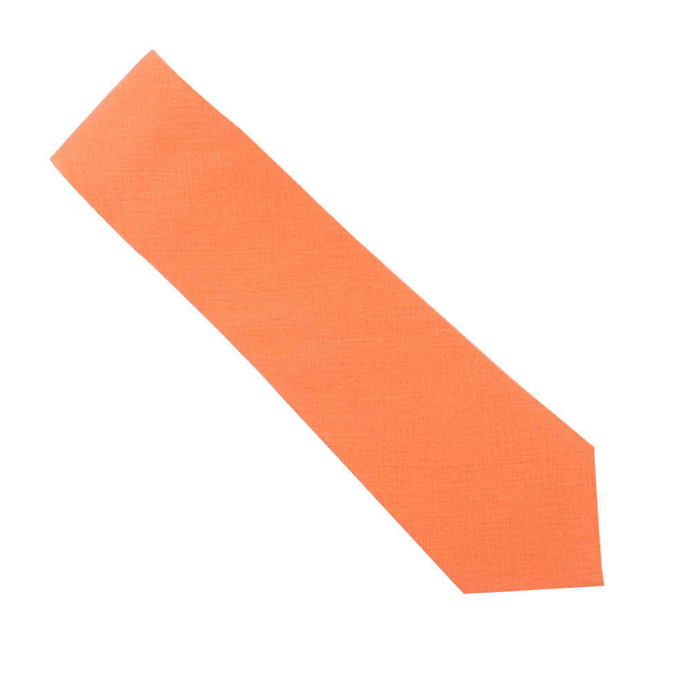 A peach orange cotton business tie from the tie and pocket square set lies diagonally on a white background, exuding dynamic flair.