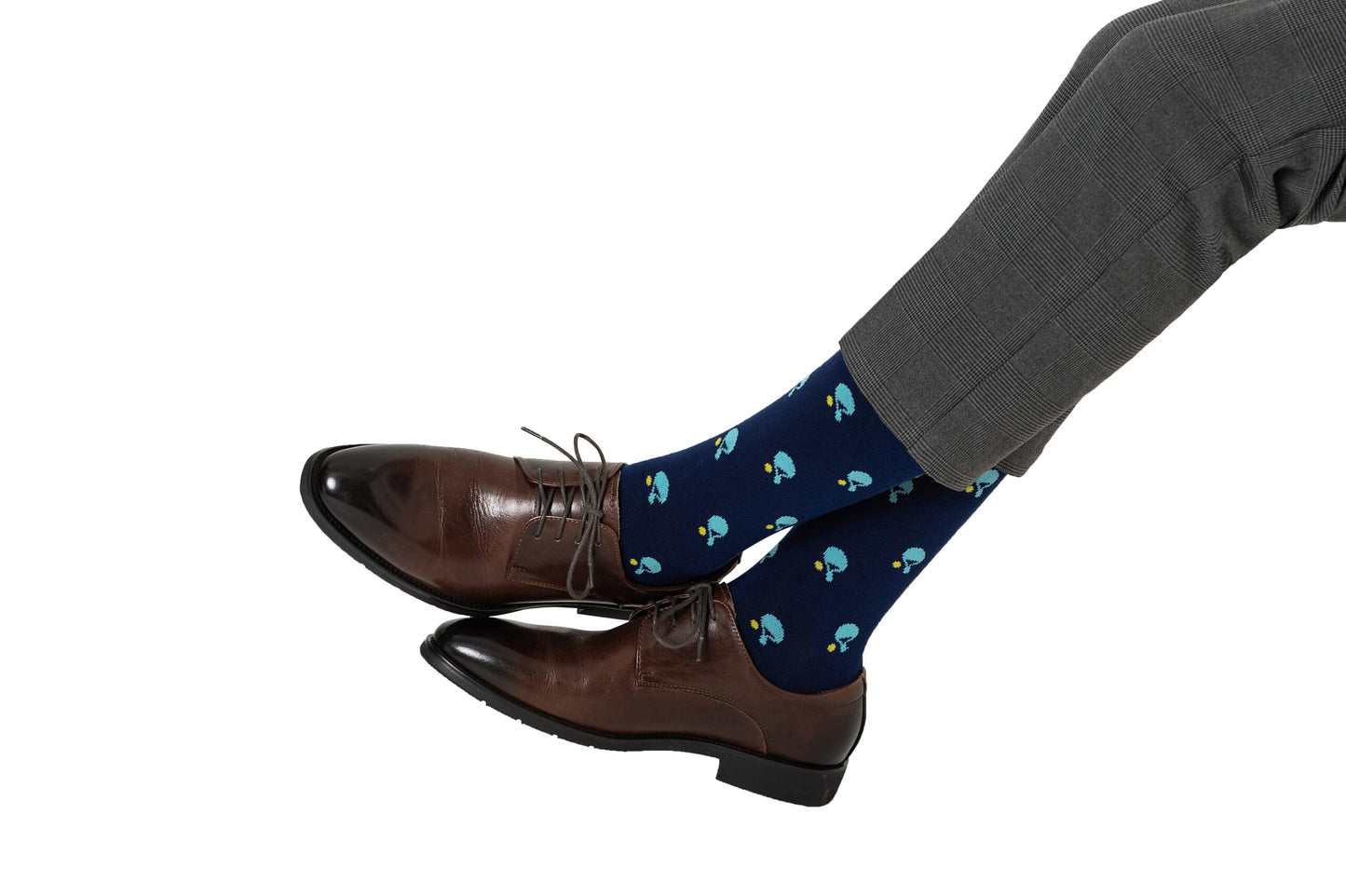 Someone wearing grey dress pants, brown leather dress shoes, and Table Tennis Socks with a racket print relaxes against a white background. The breathable fabric of the socks ensures both comfort and style.