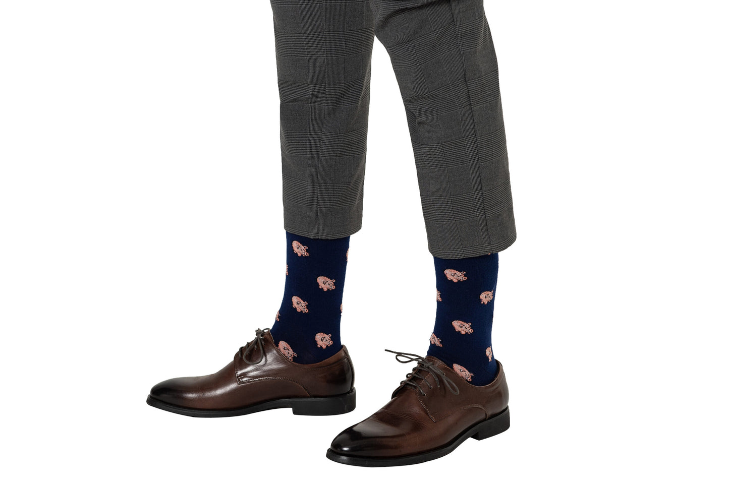 Man wearing gray pants, Piggy Bank Socks, and brown dress shoes, effortlessly blending comfort with fashion.