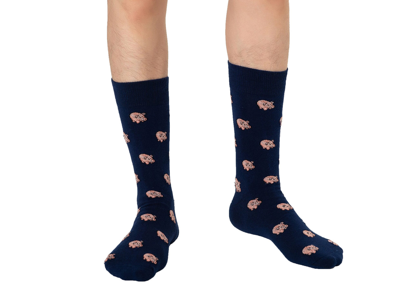 A person highlighting the Piggy Bank Socks, knee-high navy blue with a pink floral pattern, seamlessly merging comfort and style.