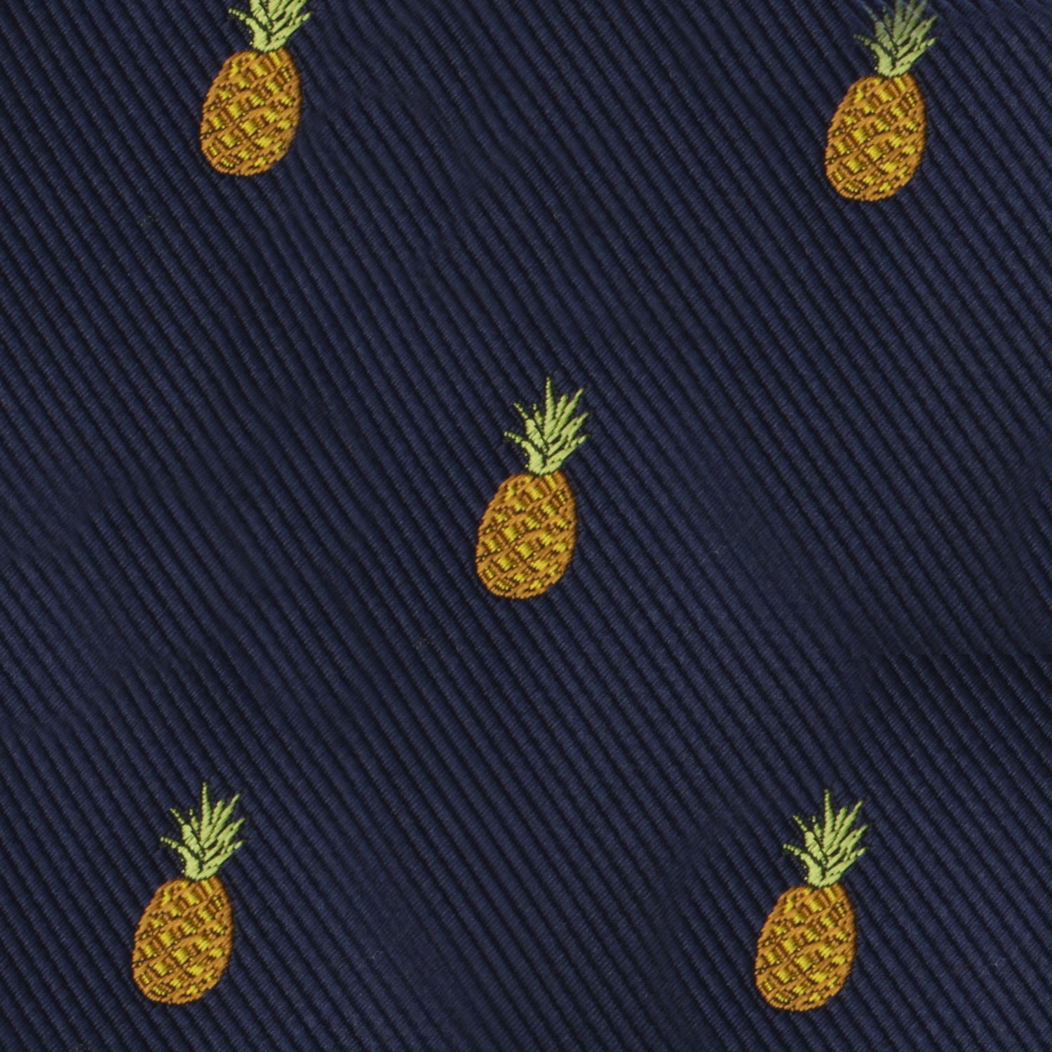 Navy blue fabric adorned with a pattern of small, embroidered yellow pineapples, evenly spaced to add a touch of tropical elegance creates the perfect Pineapple Bow Tie.